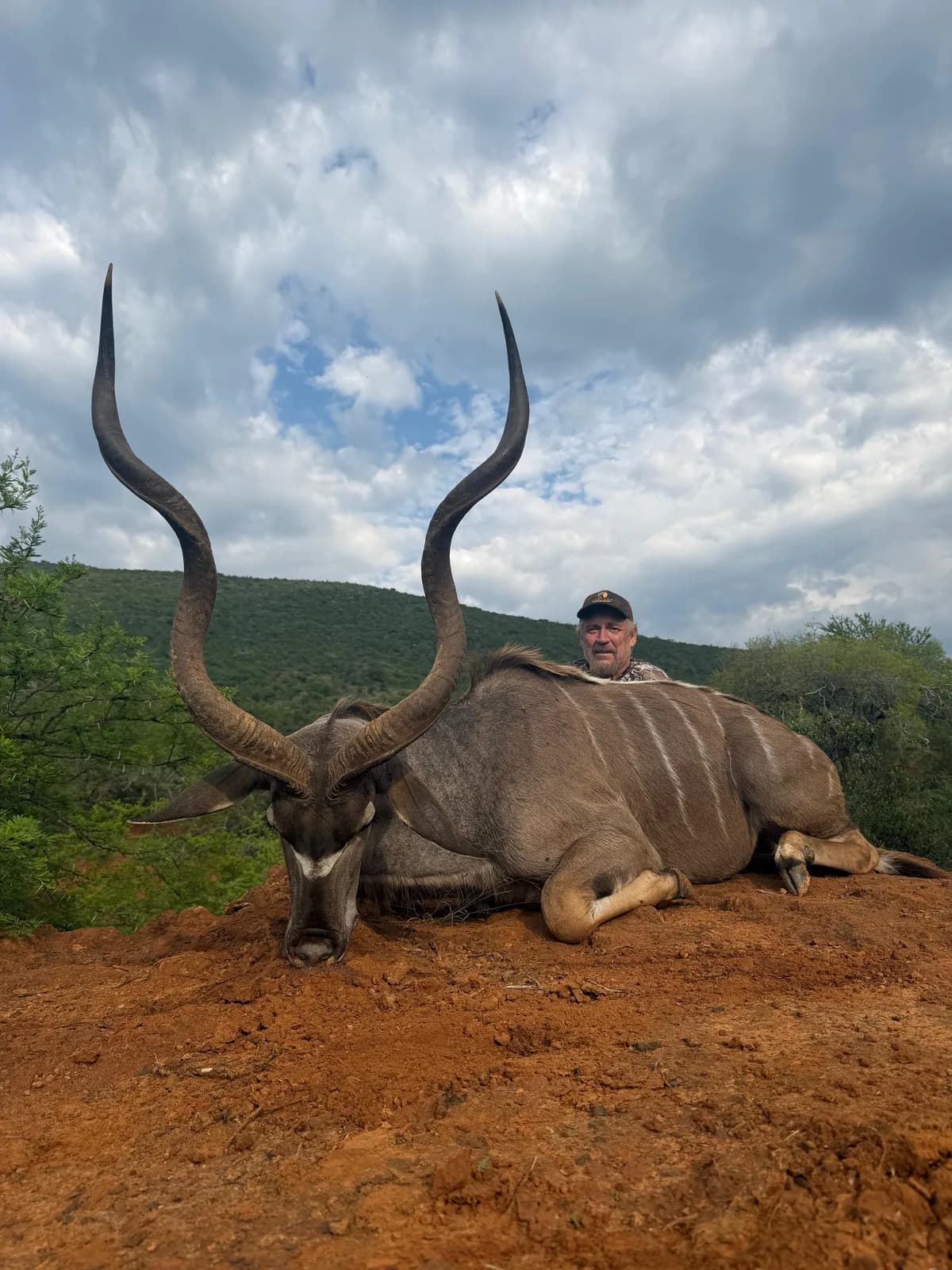 Hunter pictured behind a harvested antelope with tall spiral horns