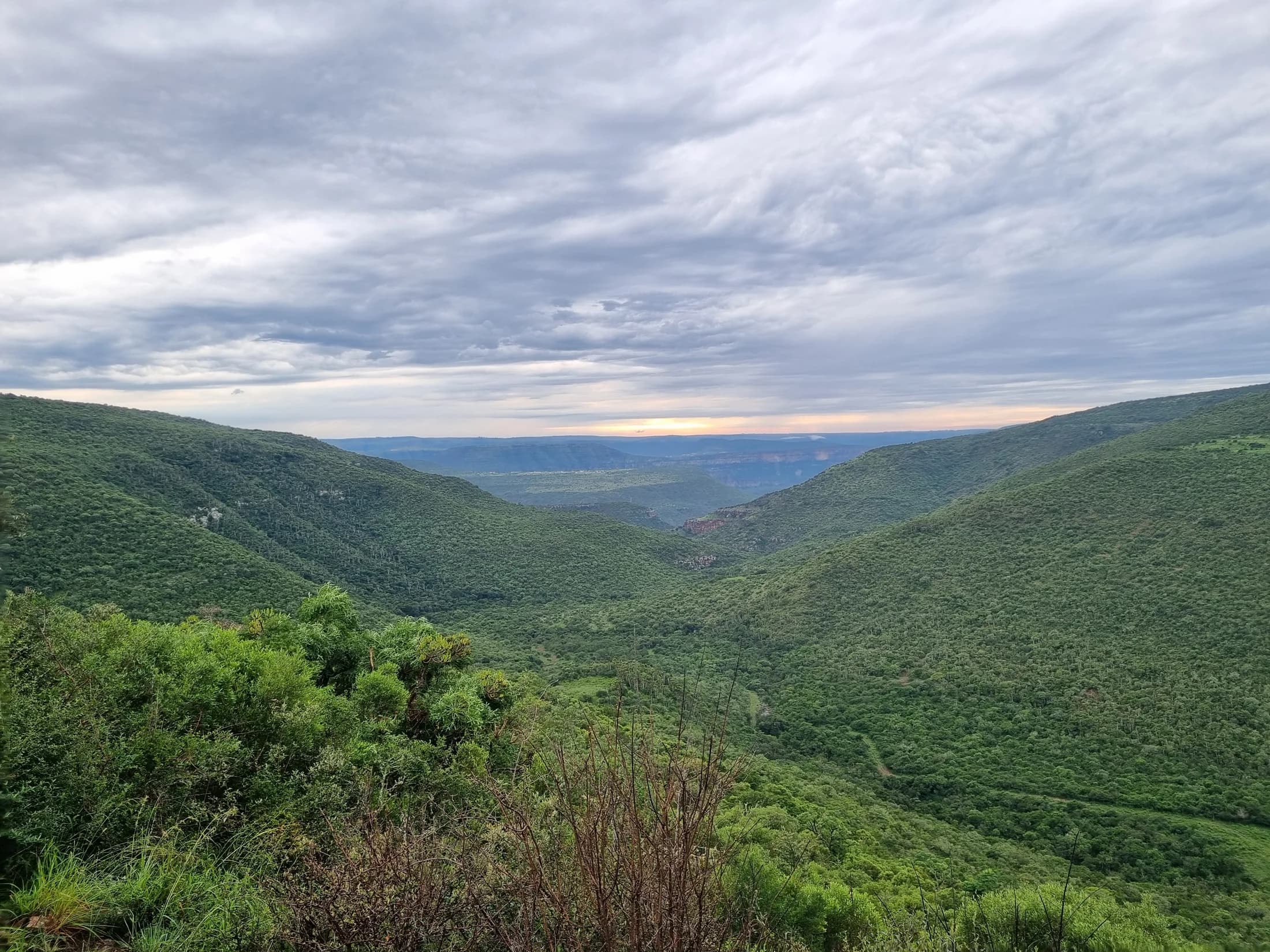 A green valley beneath layered clouds