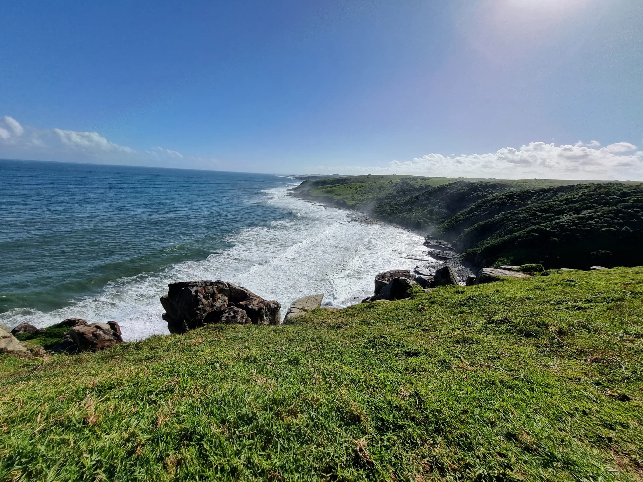 A rocky coastline meeting the blue sea