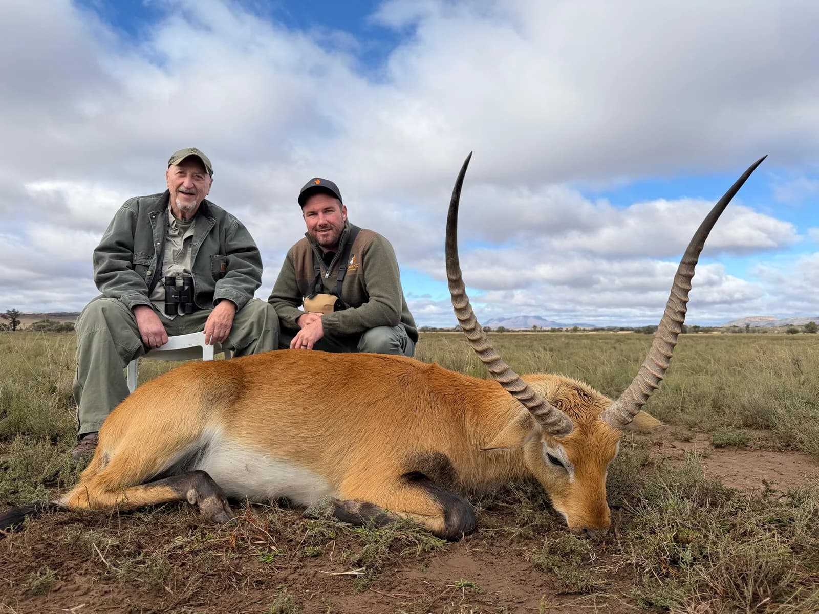 Two Garland hunters behind a harvested red lechwe