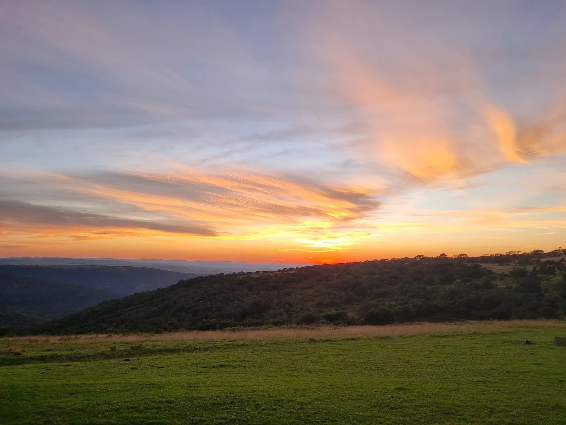 Warm sunrise light spreading across open country